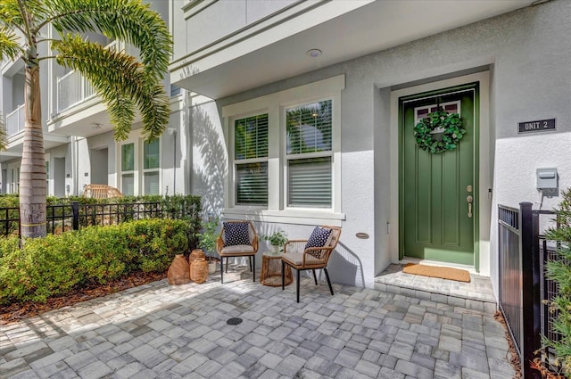 property entrance featuring stucco siding