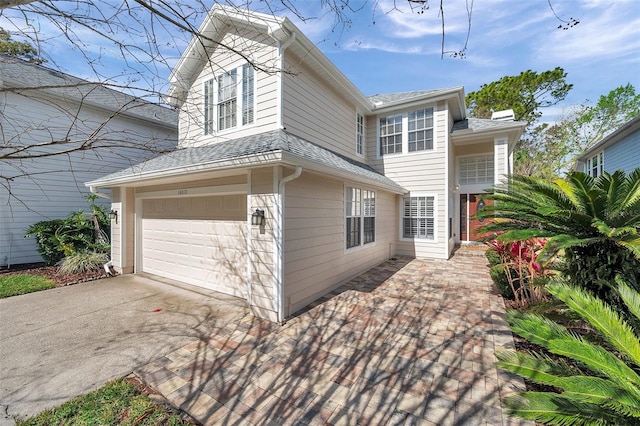 view of property exterior with a garage, concrete driveway, a shingled roof, and a chimney