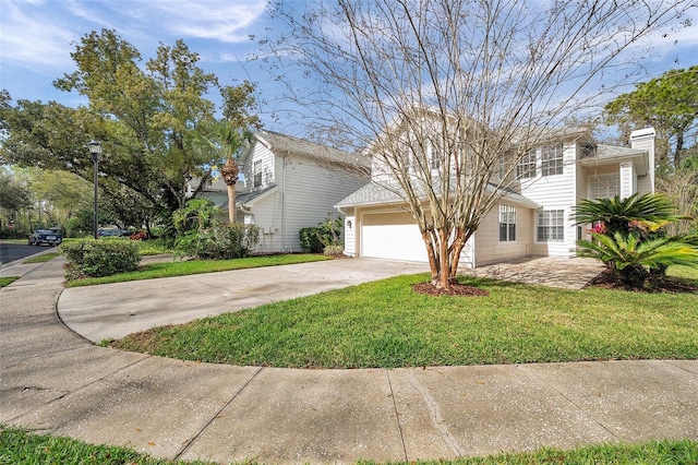 view of front of property with a garage, concrete driveway, and a front lawn