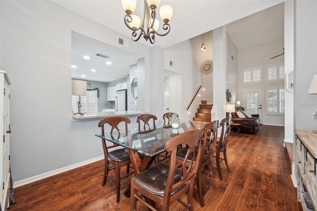 dining room with stairs, dark wood-type flooring, visible vents, and baseboards