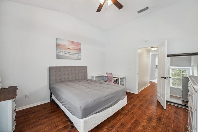 bedroom featuring a ceiling fan, visible vents, vaulted ceiling, baseboards, and dark wood-style floors