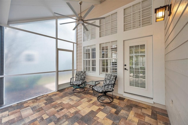 unfurnished sunroom featuring ceiling fan