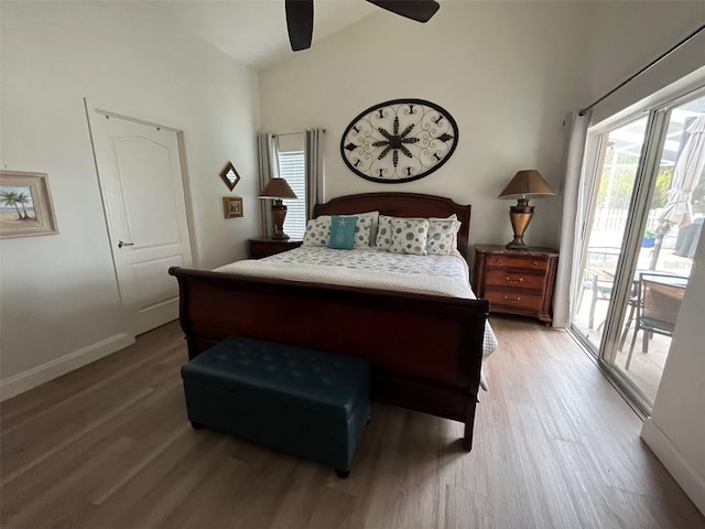 bedroom featuring a ceiling fan, light wood-style floors, vaulted ceiling, baseboards, and access to exterior