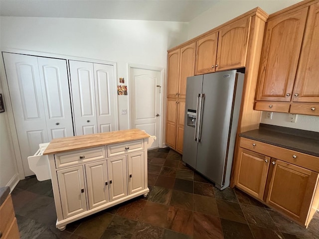 kitchen with a center island, stone finish flooring, and high end refrigerator