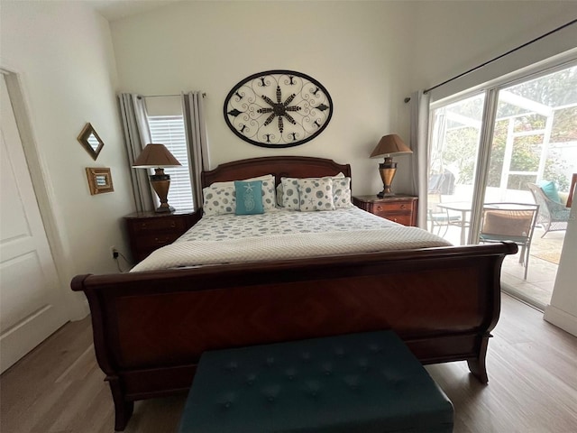 bedroom featuring light wood-type flooring and access to outside