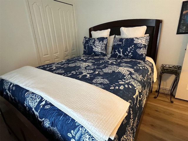 bedroom featuring a closet and wood finished floors