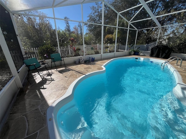 view of swimming pool featuring a fenced in pool, glass enclosure, a patio, and fence