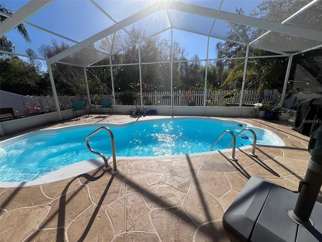 view of swimming pool with a patio area, a fenced backyard, a fenced in pool, and a lanai