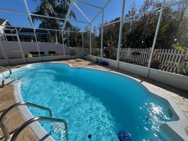 view of swimming pool featuring a fenced in pool, a patio area, a lanai, and a fenced backyard