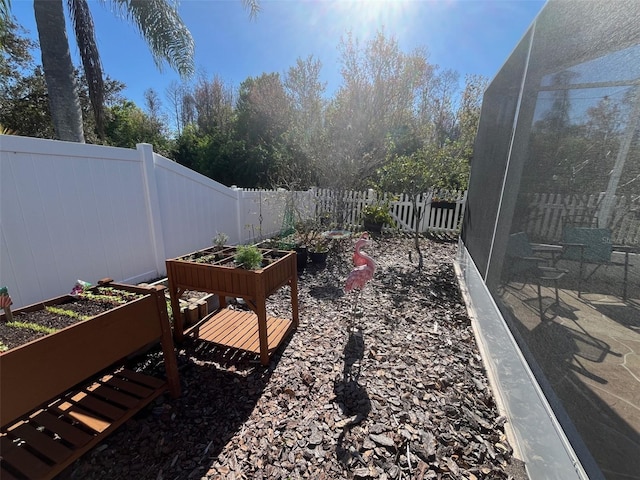 view of yard with a fenced backyard and a vegetable garden