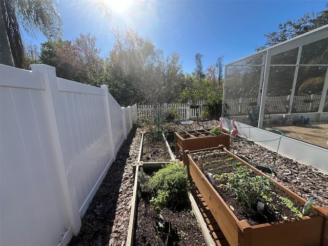 view of yard featuring fence and a garden