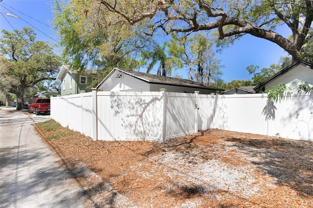 view of side of home featuring fence