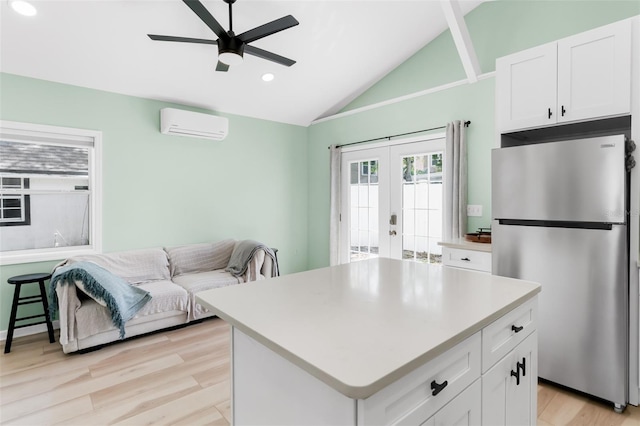 kitchen with a wall mounted AC, freestanding refrigerator, ceiling fan, vaulted ceiling, and french doors