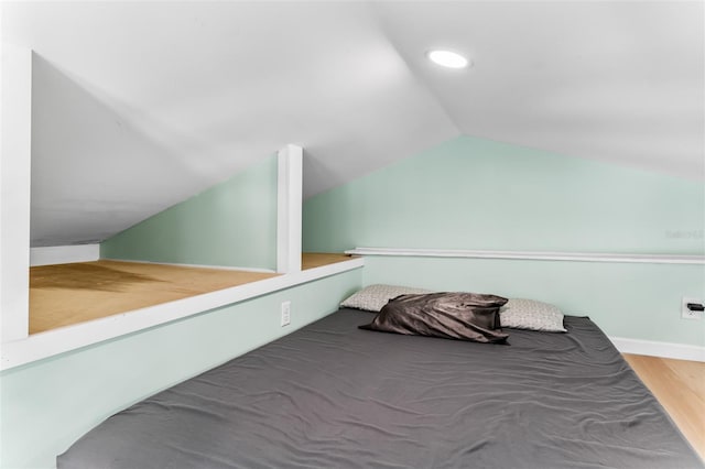 bedroom featuring recessed lighting, wood finished floors, and vaulted ceiling