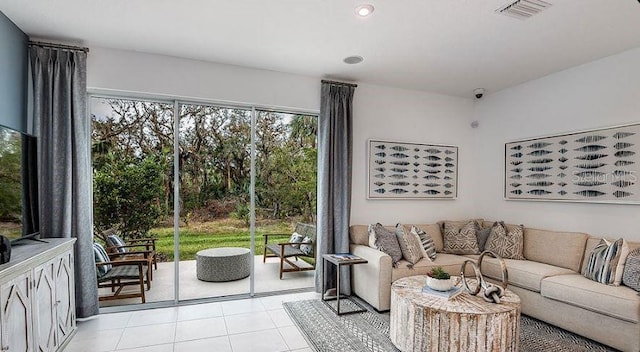 living area featuring light tile patterned flooring, visible vents, and recessed lighting