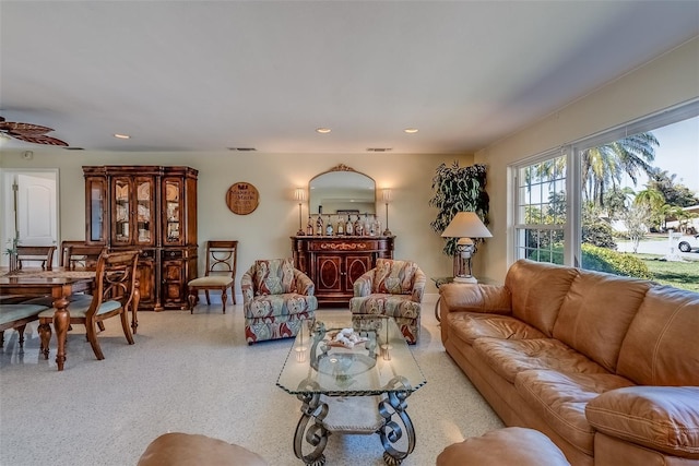 living area with visible vents, speckled floor, a ceiling fan, and recessed lighting