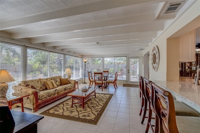 sunroom featuring beamed ceiling and visible vents