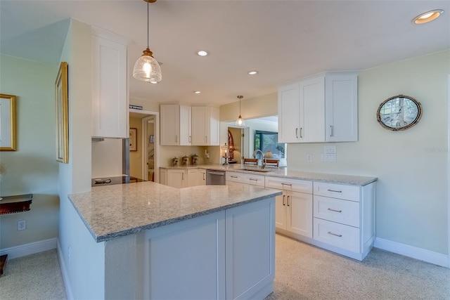 kitchen with stainless steel dishwasher, white cabinetry, and a sink