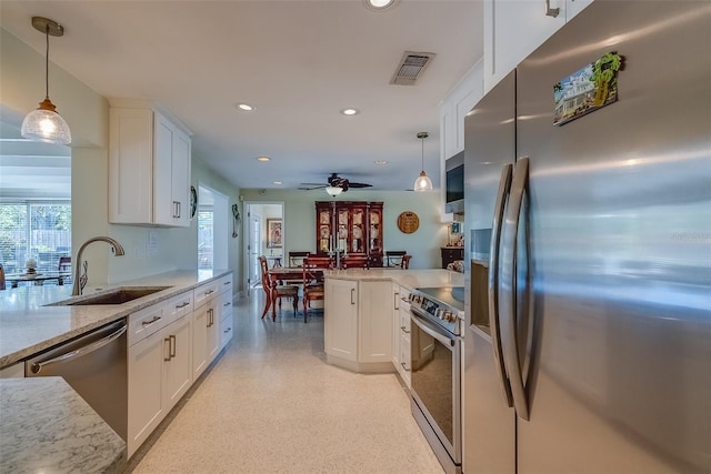 kitchen with appliances with stainless steel finishes, recessed lighting, white cabinets, and a sink