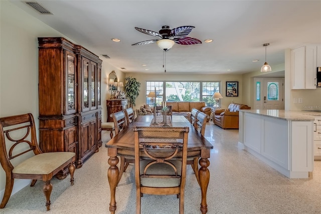 dining room featuring light speckled floor, a ceiling fan, visible vents, and recessed lighting