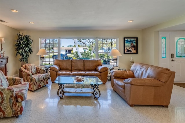 living area with speckled floor, a wealth of natural light, and recessed lighting