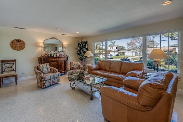 living room featuring recessed lighting, visible vents, baseboards, and speckled floor