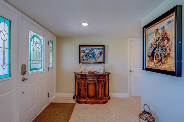 entryway with recessed lighting and baseboards