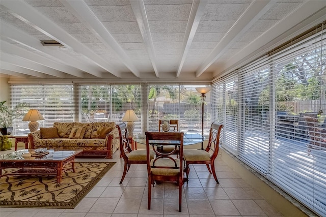 sunroom featuring beamed ceiling