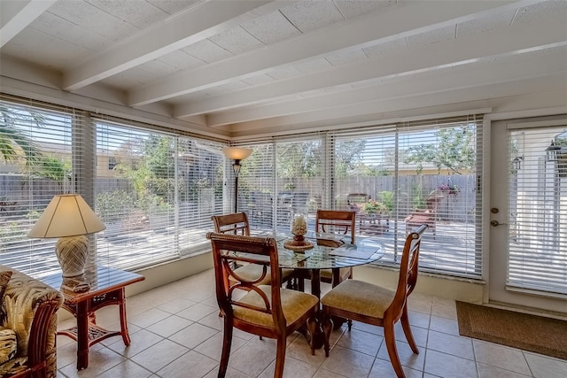 sunroom with beam ceiling and a healthy amount of sunlight