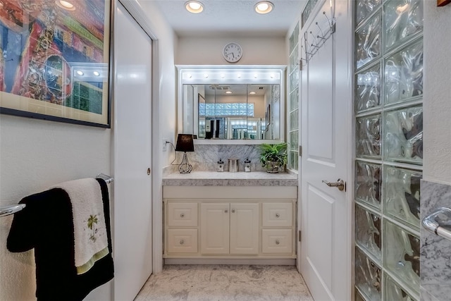 bathroom featuring recessed lighting and vanity