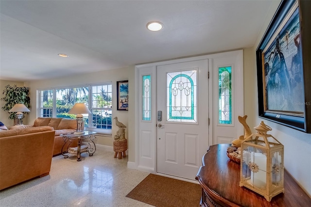 entryway with speckled floor, recessed lighting, and baseboards