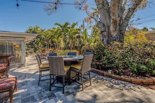 view of patio with outdoor dining space and fence