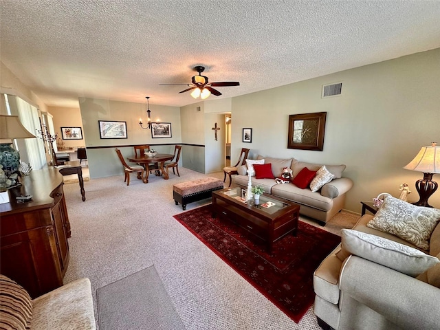 living area featuring a textured ceiling, ceiling fan, carpet flooring, and visible vents