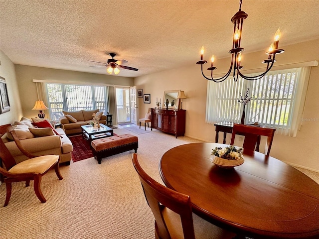 living room featuring light carpet, a textured ceiling, and ceiling fan with notable chandelier