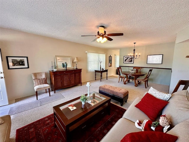 living area with a textured ceiling and ceiling fan with notable chandelier