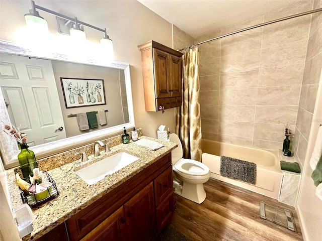 full bath featuring toilet, shower / tub combo, wood finished floors, visible vents, and vanity