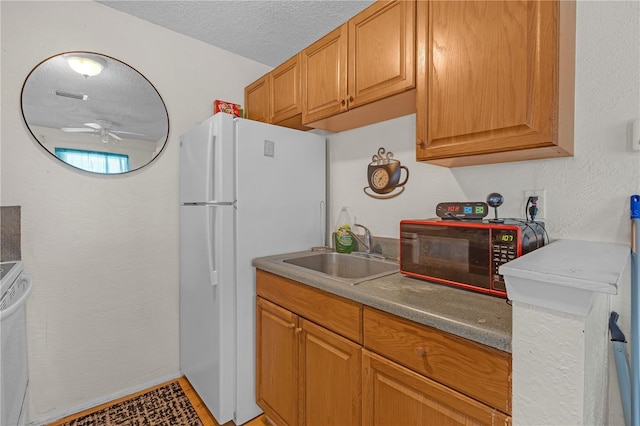 776 18th Ave S, Saint Petersburg, FL 33705 - kitchen featuring a textured ceiling, ceiling fan, a textured wall, a sink, and freestanding refrigerator