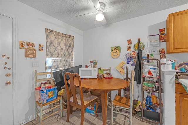 776 18th Ave S, Saint Petersburg, FL 33705 - dining area with ceiling fan, a textured ceiling, and light tile patterned flooring