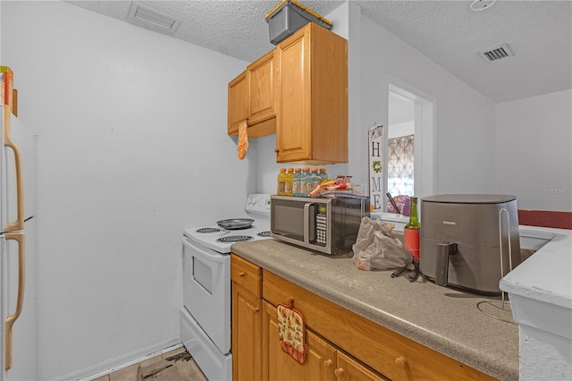 776 18th Ave S, Saint Petersburg, FL 33705 - kitchen with visible vents, white appliances, light countertops, and a textured ceiling