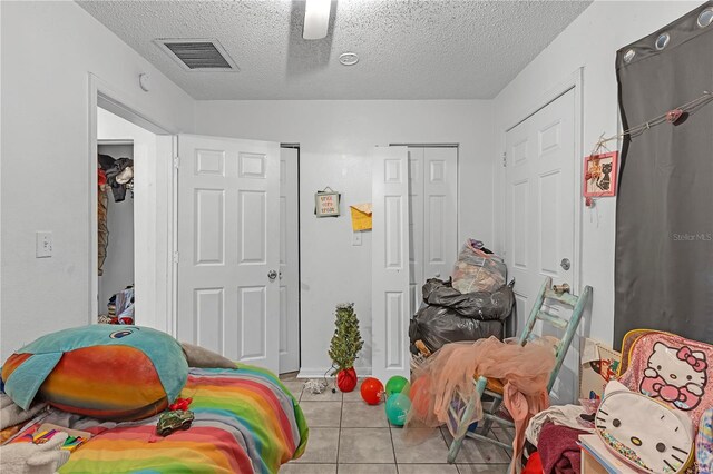 776 18th Ave S, Saint Petersburg, FL 33705 - bedroom featuring ceiling fan, visible vents, a textured ceiling, and light tile patterned flooring