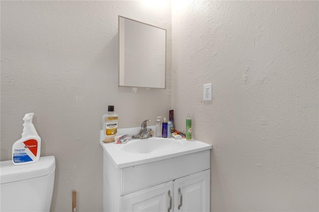 776 18th Ave S, Saint Petersburg, FL 33705 - half bath featuring toilet, a textured wall, and vanity