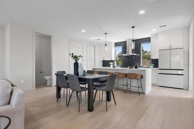 dining room with visible vents, light wood-style flooring, and recessed lighting