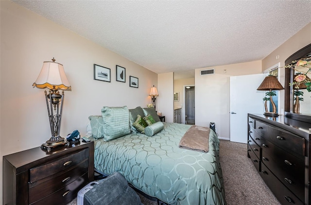 carpeted bedroom featuring visible vents, a textured ceiling, and ensuite bathroom