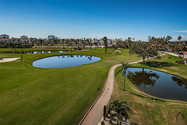 view of home's community featuring a water view and a lawn