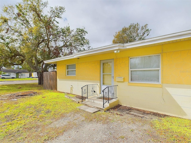 view of front facade with concrete block siding