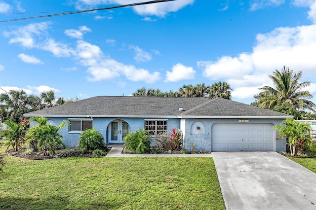 single story home with concrete driveway, an attached garage, french doors, a front lawn, and stucco siding