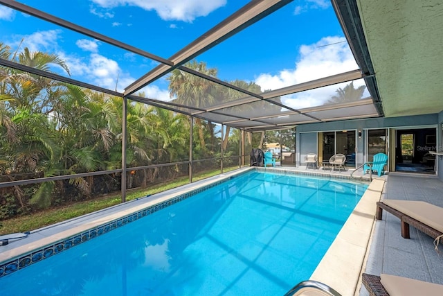 pool with a patio and glass enclosure