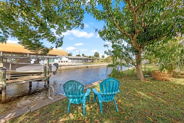 dock area with a water view, fence, and boat lift