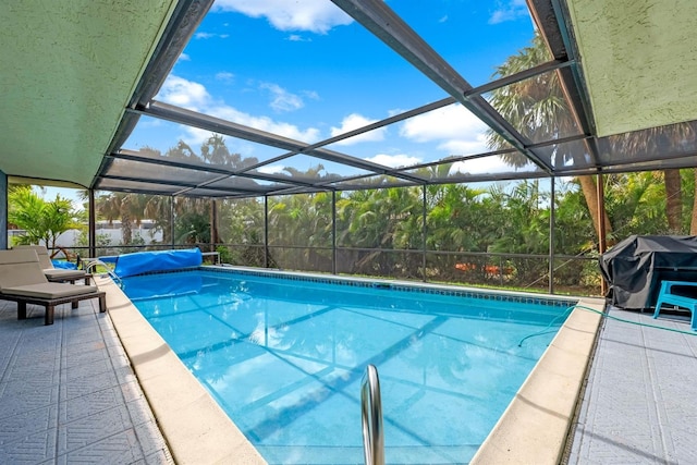 pool with a lanai, a patio, and area for grilling