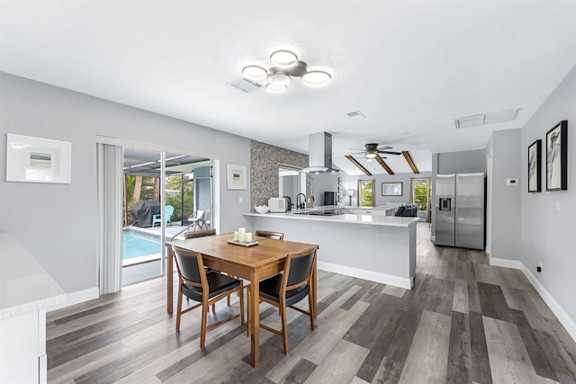 dining space with a healthy amount of sunlight, dark wood-style floors, and visible vents